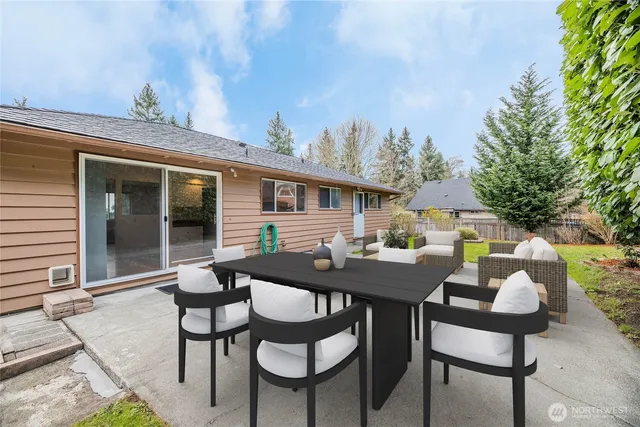 a view of a patio with table and chairs and potted plants