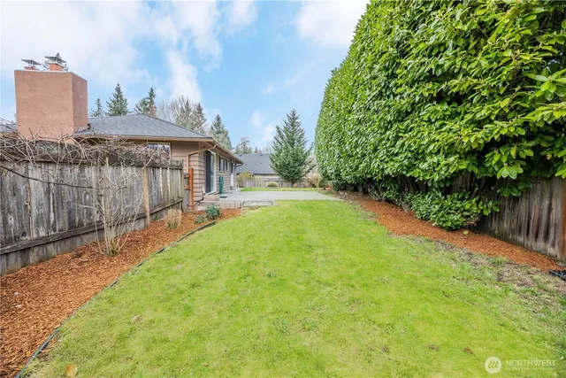 a view of a house with brick walls and a small yard