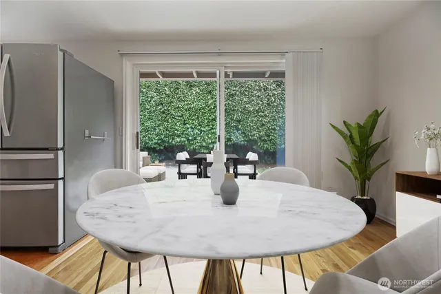 a dining room with furniture and wooden floor