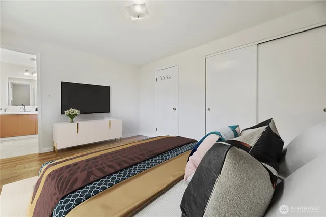 a bedroom with a bed and a flat screen tv