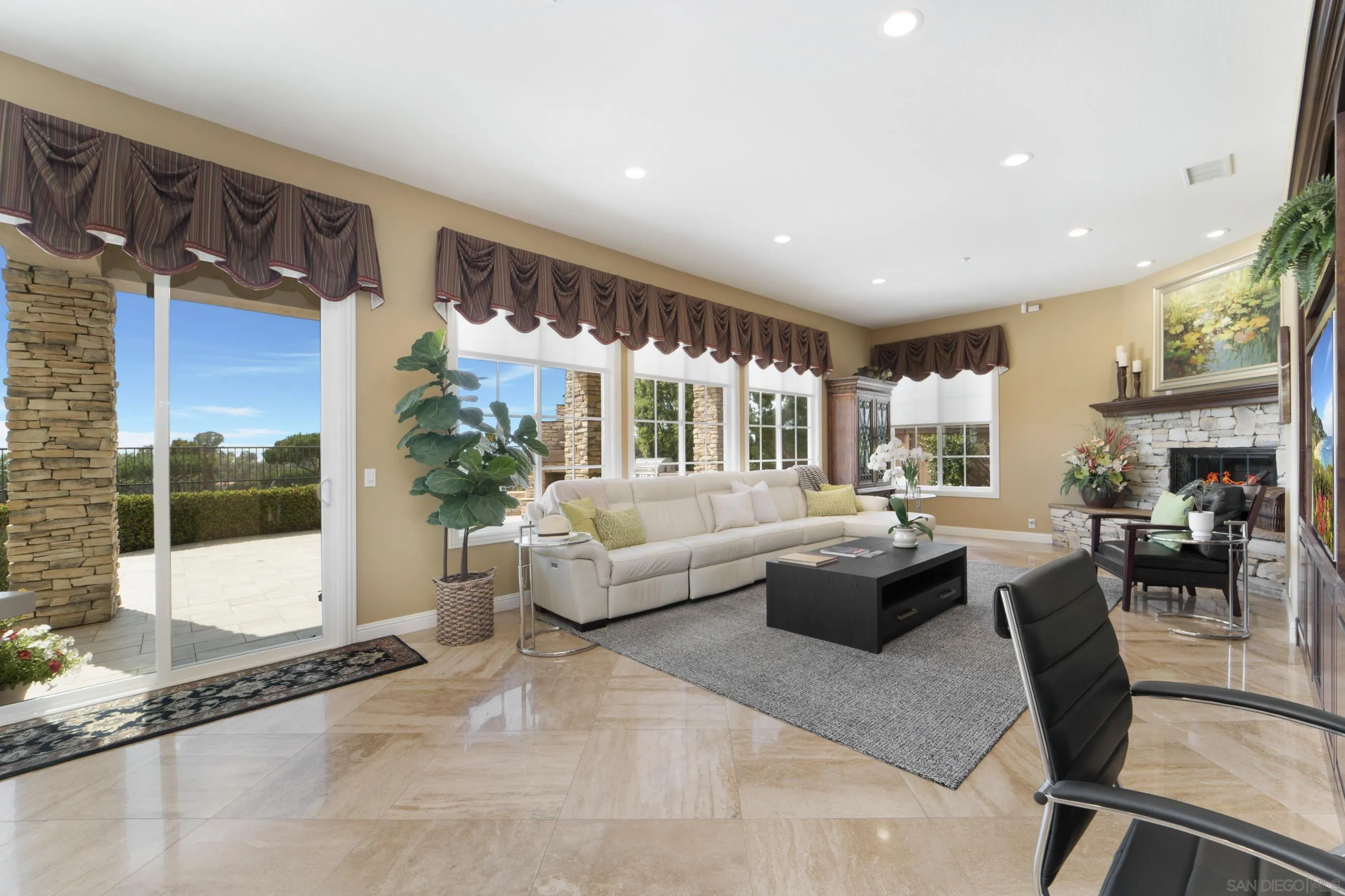 698 Cypress Hills Drive Encinitas, CA 92024 - Photo 12 of 67 a living room with fireplace furniture and a floor to ceiling window