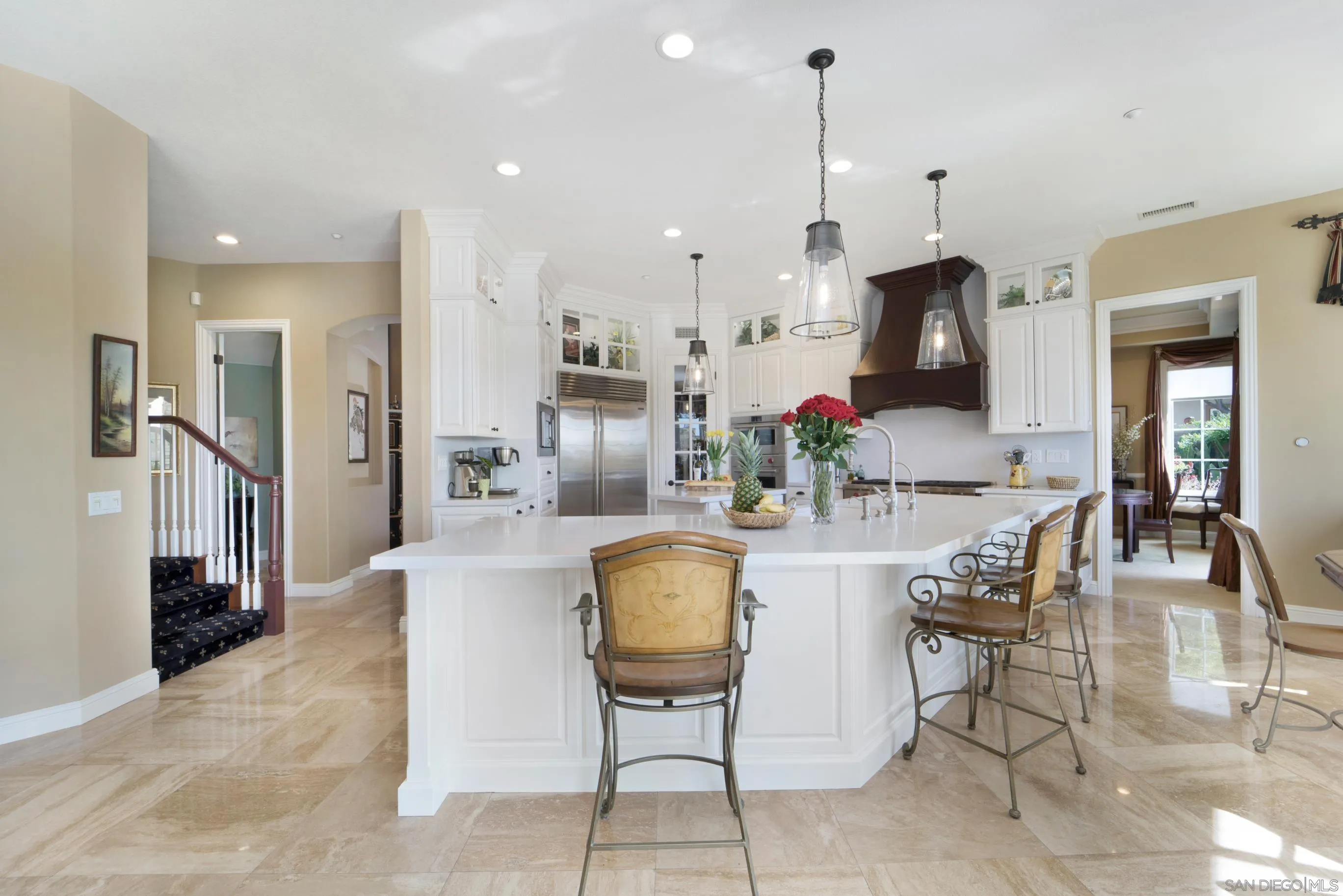 698 Cypress Hills Drive Encinitas, CA 92024 - Photo 15 of 67 a kitchen with stainless steel appliances kitchen island granite countertop a refrigerator and a stove top oven with white cabinets