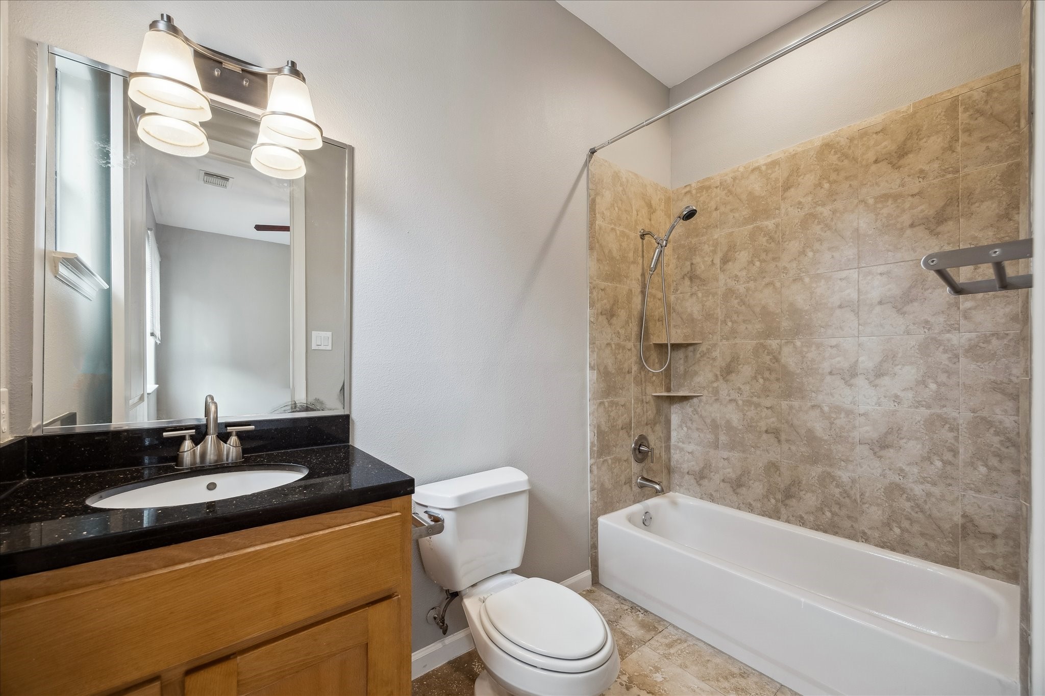 802 Waverly Street, Unit D Houston, TX 77007 - Photo 21 of 30 a bathroom with a granite countertop sink toilet mirror and shower