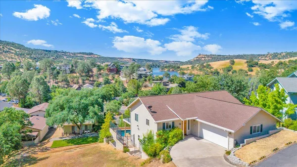 an aerial view of a house with a big yard and potted plants