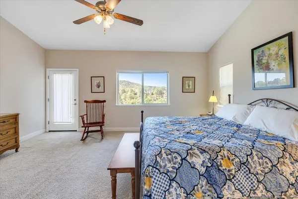 a bedroom with a bed and a painting on the wall