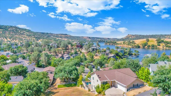a living room with furniture fireplace and a large window