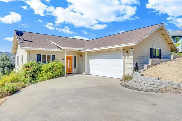 a living room with fireplace furniture and a large window