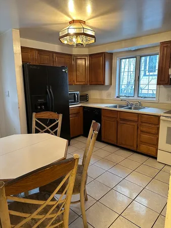 a kitchen with stainless steel appliances kitchen island granite countertop a sink and cabinets