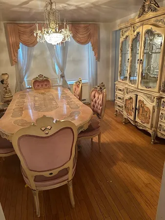 a view of a dining room with furniture and chandelier