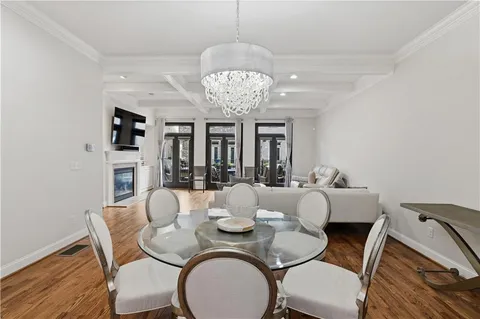 a view of a dining room with furniture wooden floor and chandelier
