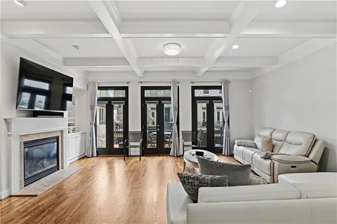 a living room with furniture large window and a fireplace