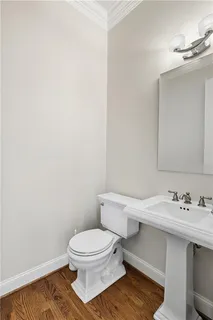 a white toilet sitting next to a bathroom sink