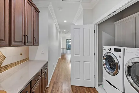 a view of a hallway with washer and dryer
