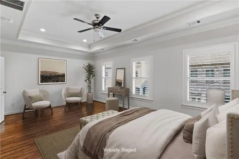 a bedroom with a bed a couch and a large window