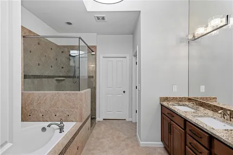 a bathroom with a bathtub and a shower