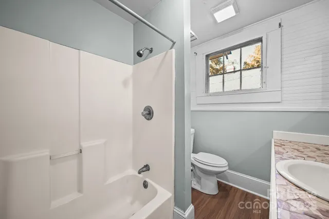 a bathroom with a sink a toilet and a bathtub