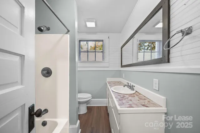 a bathroom with a sink toilet and shower