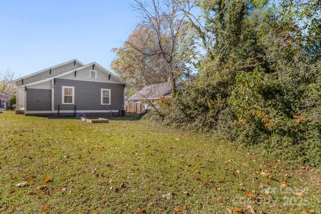 a front view of house with yard and trees around