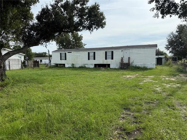 a view of a house with a back yard