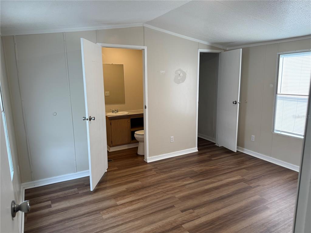 340 South Hankin Road Bartow, FL 33830 - Photo 11 of 16 an empty room with wooden floor and a window