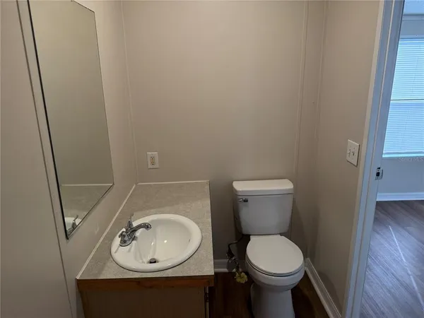 a bathroom with a sink toilet and a mirror