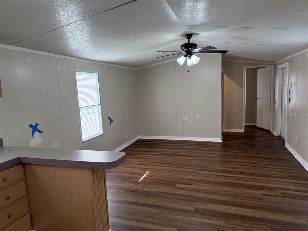 340 South Hankin Road Bartow, FL 33830 - Photo 3 of 16 a view of an empty room with wooden floor and a ceiling fan
