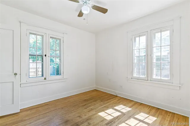 a view of a room with wooden floor ceiling fan