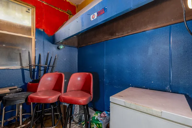 a blue room with table and chairs