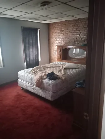 a bedroom with bed and a fireplace