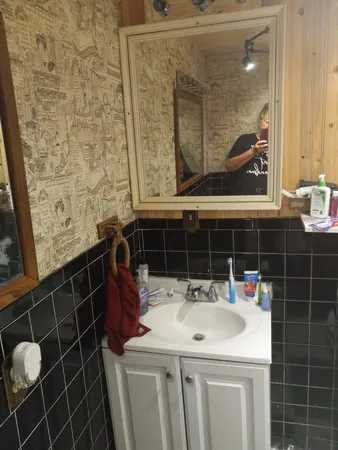 a bathroom with a sink and mirror