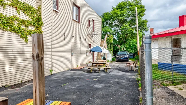 a view of a chair and tables in the patio in front of a house