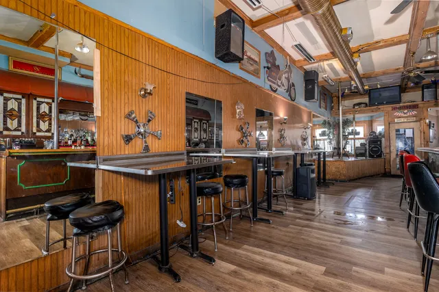 a view of a chairs and table on the wooden deck