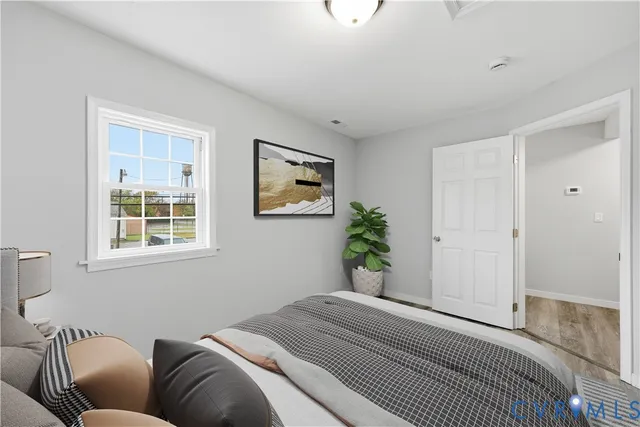 a bedroom with a large bed and a window