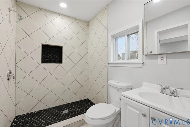 a bathroom with a sink toilet and vanity