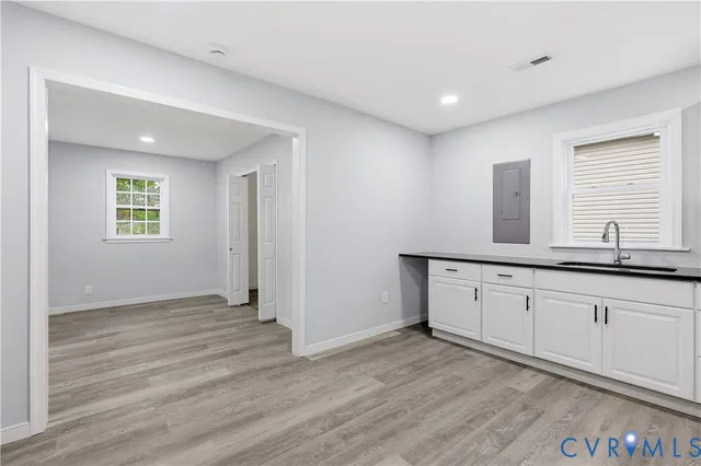 a view of a kitchen with sink and mirror
