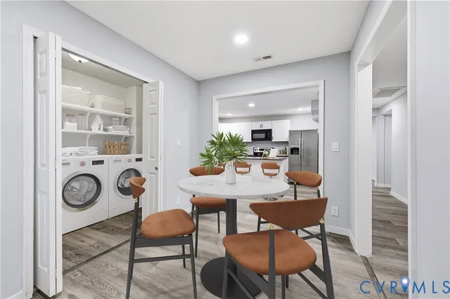 a view of a dining room with furniture and wooden floor