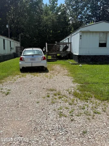 a car parked in front of white house