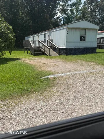 a view of a backyard with plants and a patio