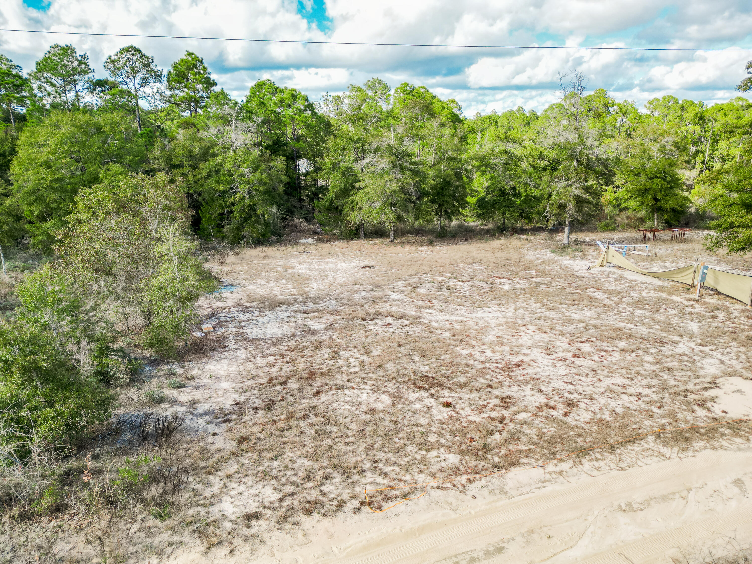 4712 Canary Way Crestview, FL 32539 - Photo 12 of 17 a view of a yard with plants and wooden fence