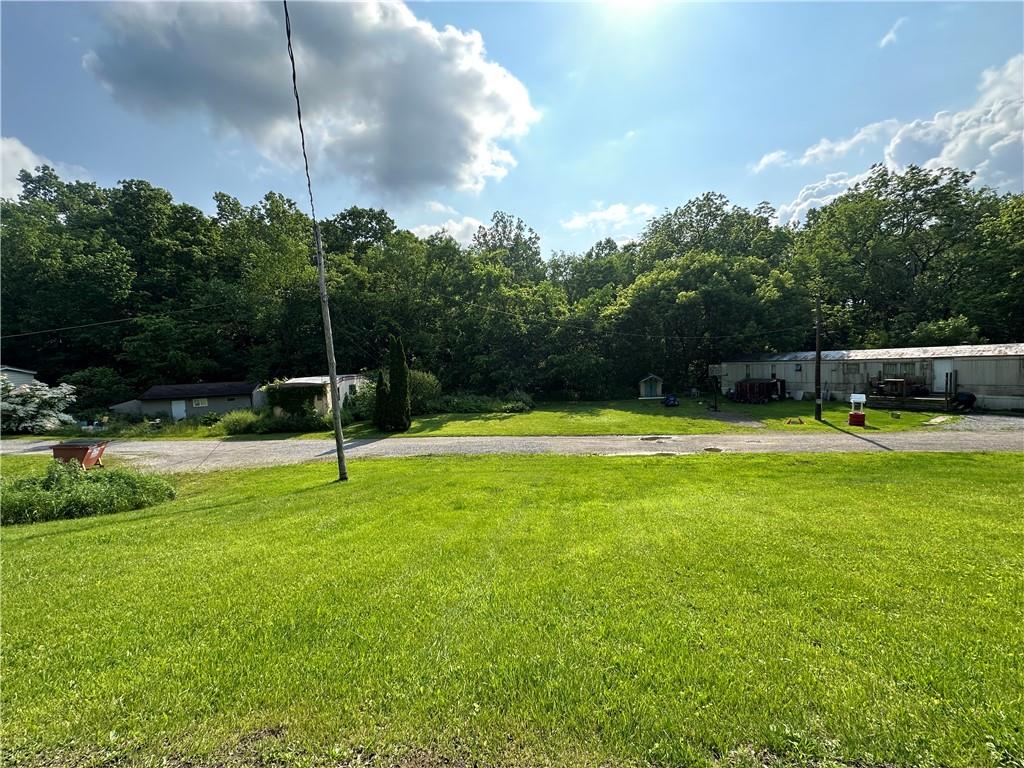 20e Engle Road Industry, PA 15052 - Photo 5 of 5 a swimming pool with lots of green space and trees in the background