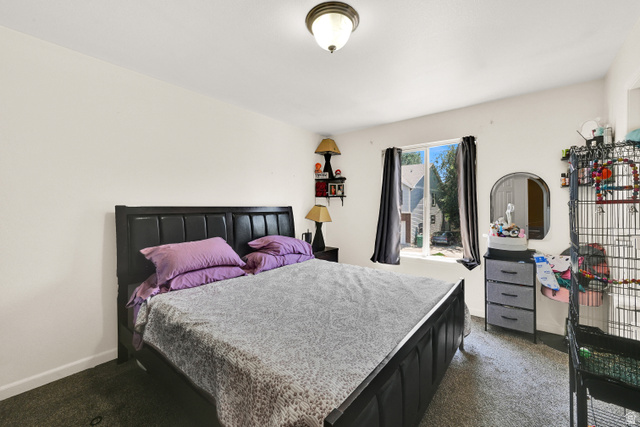 116 4th Street South Ogden, UT 84404 - Photo 5 of 7 Carpeted bedroom with a single window featuring dark drapes