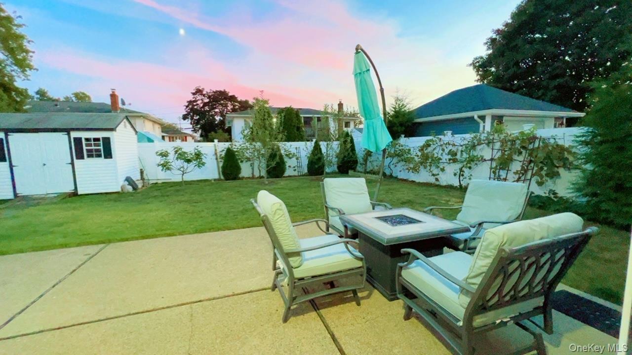 12 Terrace View Road Farmingdale, NY 11735 - Photo 19 of 21 a view of a chair and table in backyard of the house