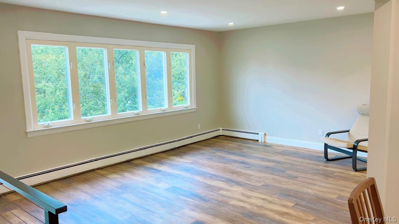 12 Terrace View Road Farmingdale, NY 11735 - Photo 5 of 21 a view of an empty room with wooden floor and a window