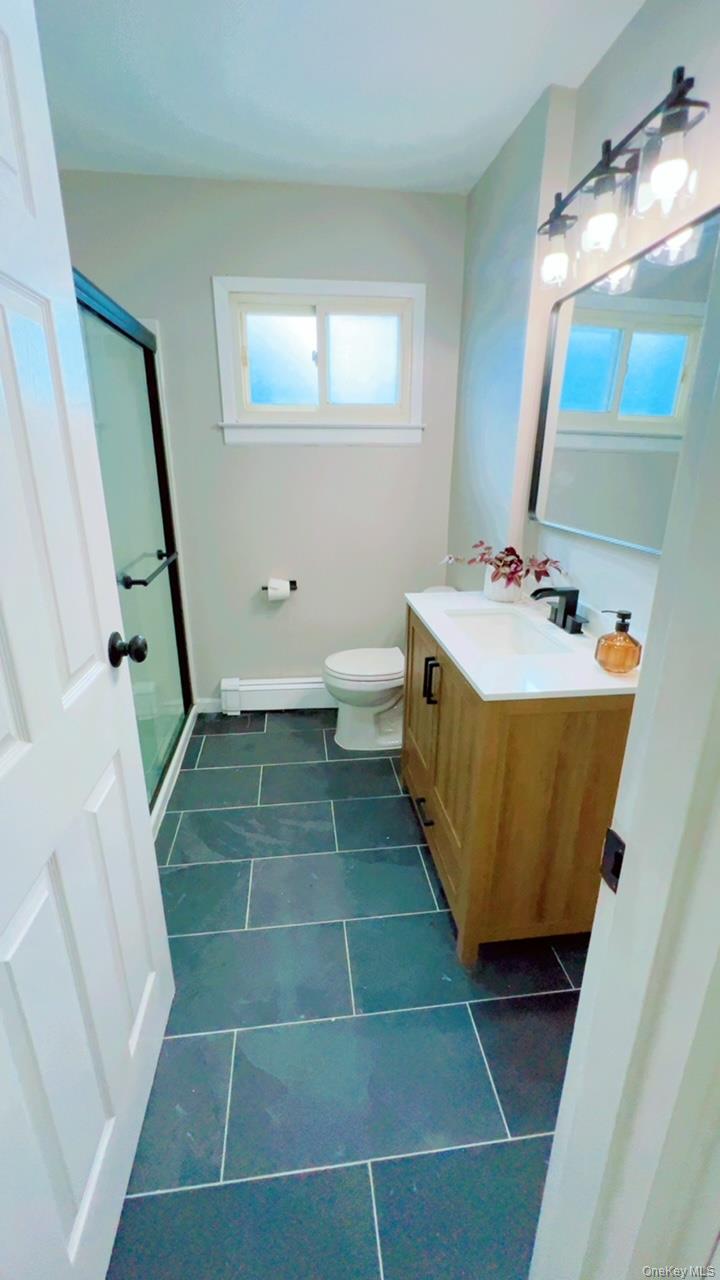 12 Terrace View Road Farmingdale, NY 11735 - Photo 8 of 21 a bathroom with a sink a toilet and a mirror