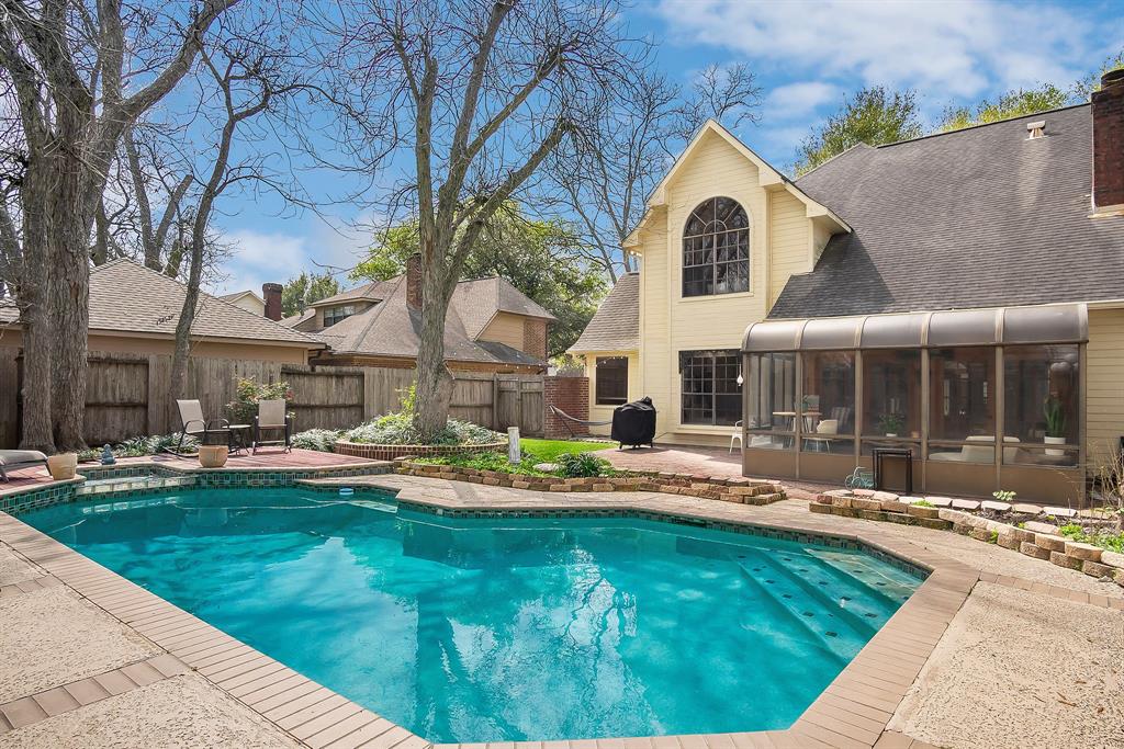Enjoy the hot summer months sipping your favorite beverage in your backyard oasis! Complete with a sparkling pool, enclosed glass sunroom (with window A/C unit), plenty of yard space for the dogs and a patio space for your family barbecues!