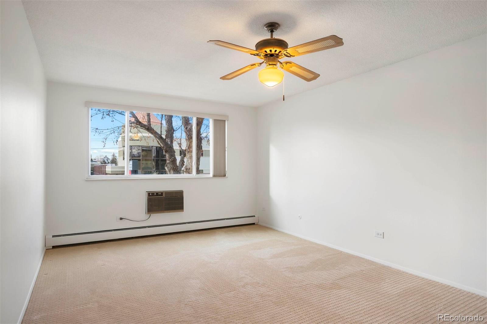 580 South Clinton Street, Unit 9B Denver, CO 80247 - Photo 15 of 30 an empty room with window and ceiling fan