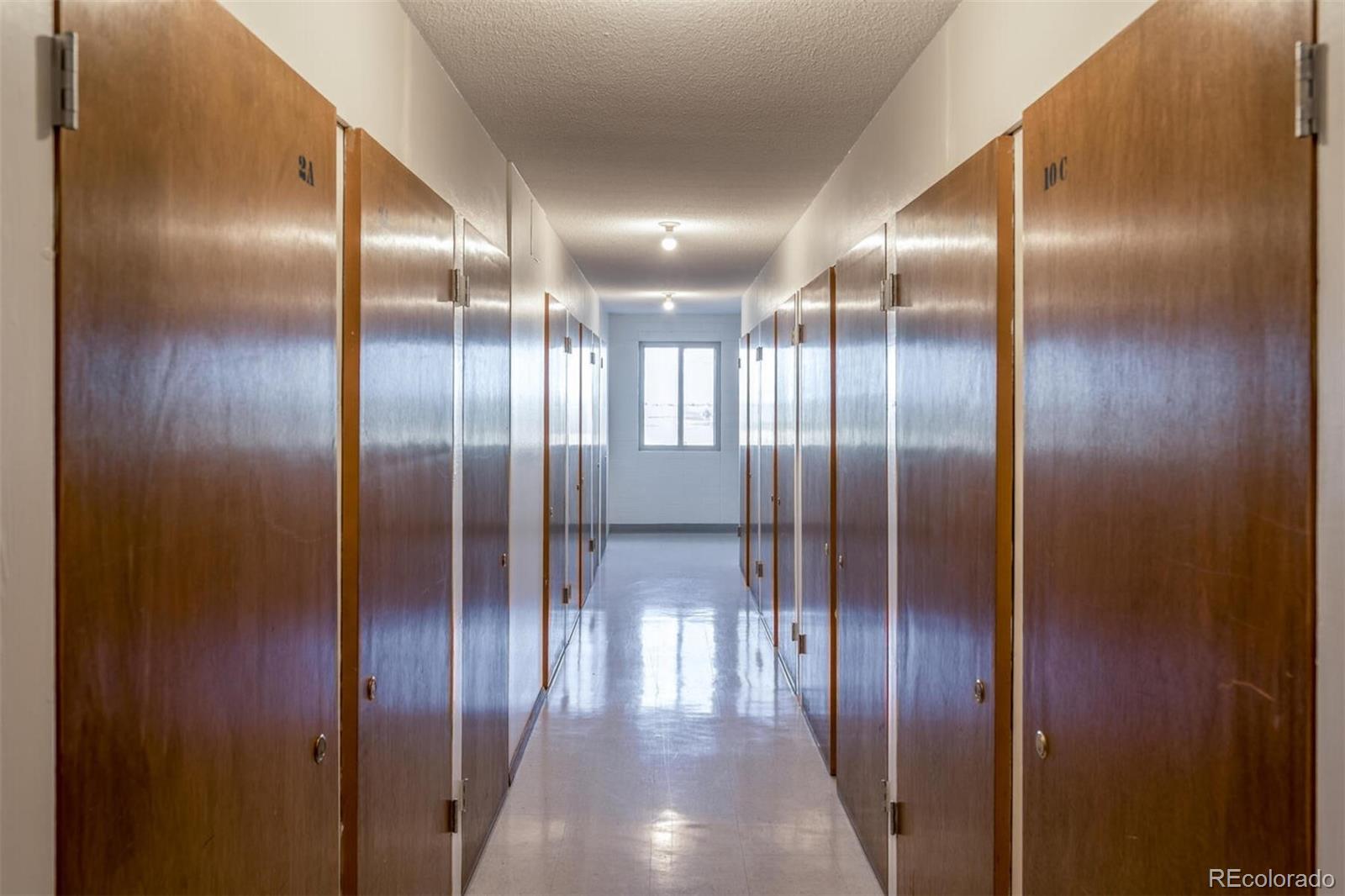 580 South Clinton Street, Unit 9B Denver, CO 80247 - Photo 22 of 30 an empty room with wooden floor