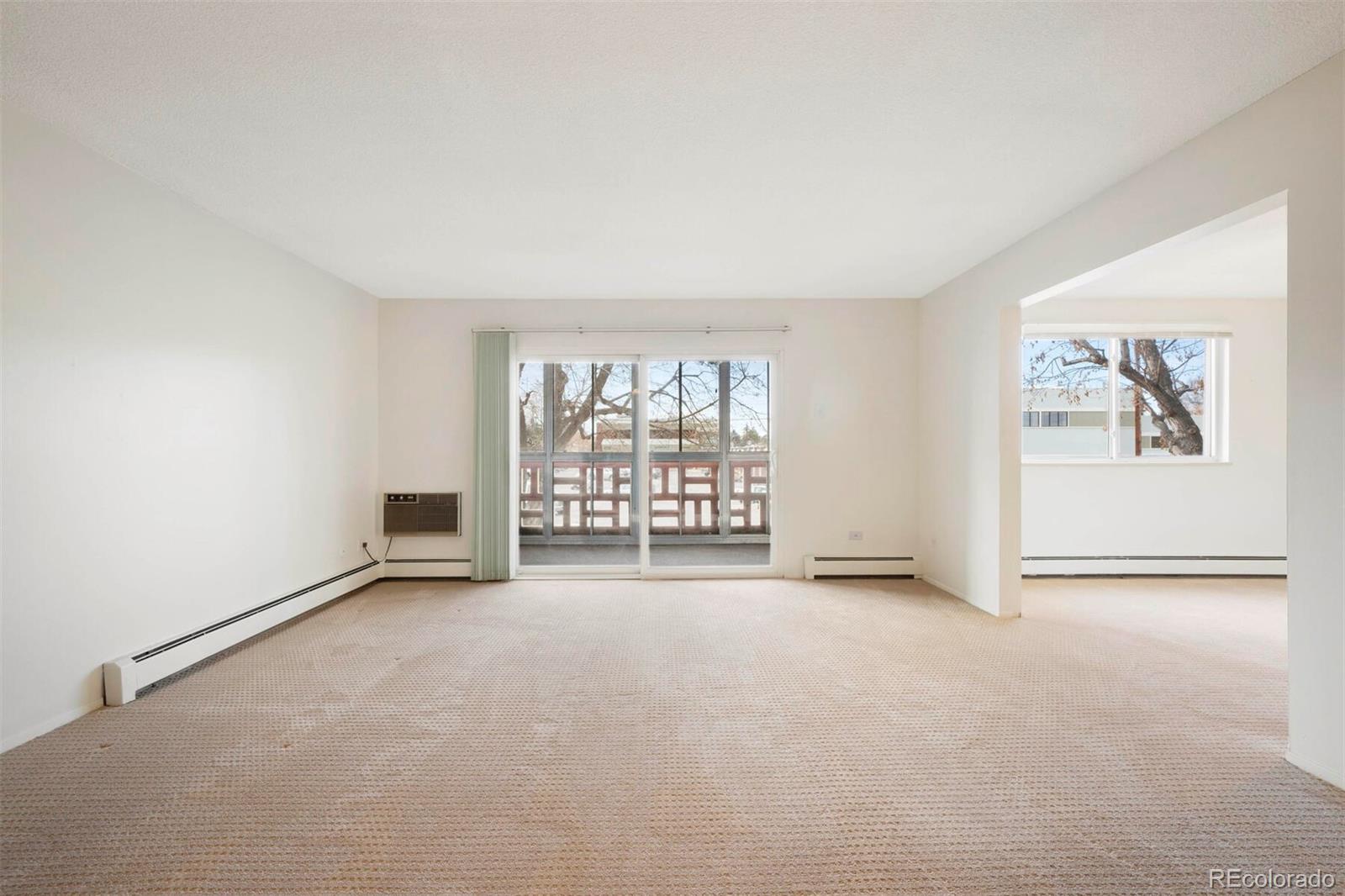 580 South Clinton Street, Unit 9B Denver, CO 80247 - Photo 5 of 30 an empty room with windows