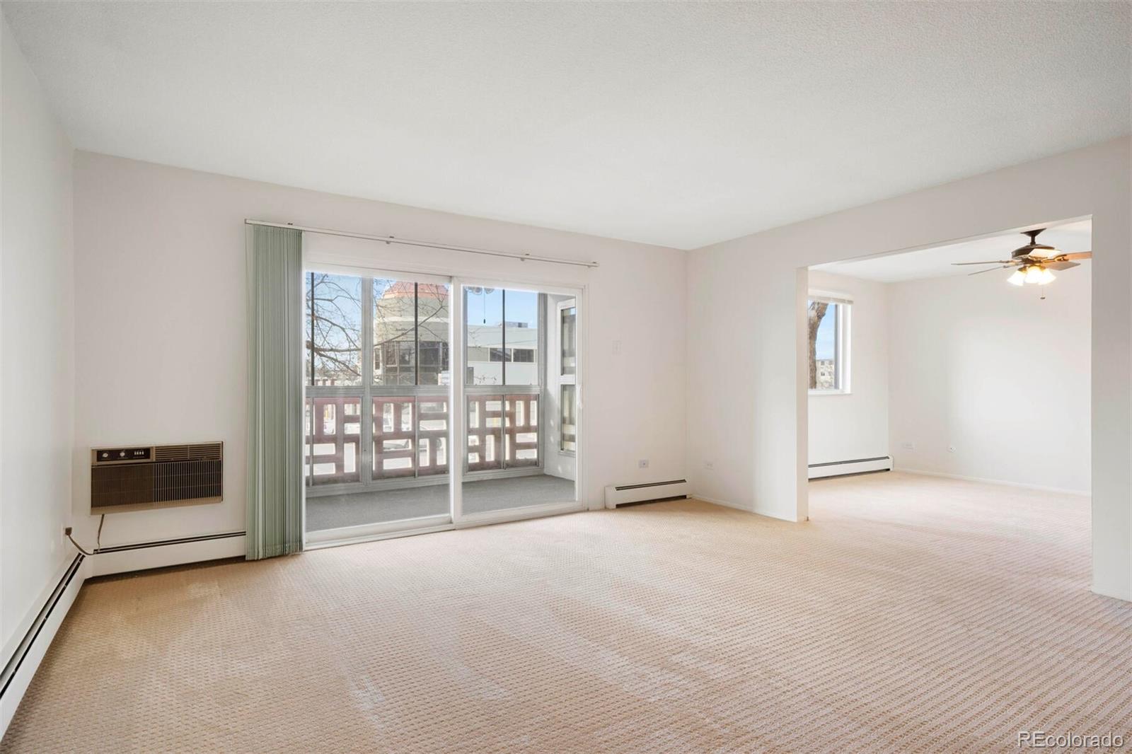 580 South Clinton Street, Unit 9B Denver, CO 80247 - Photo 8 of 30 a view of an empty room with a window