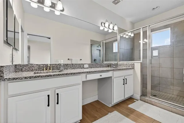 a bathroom with a sink double vanity and a mirror